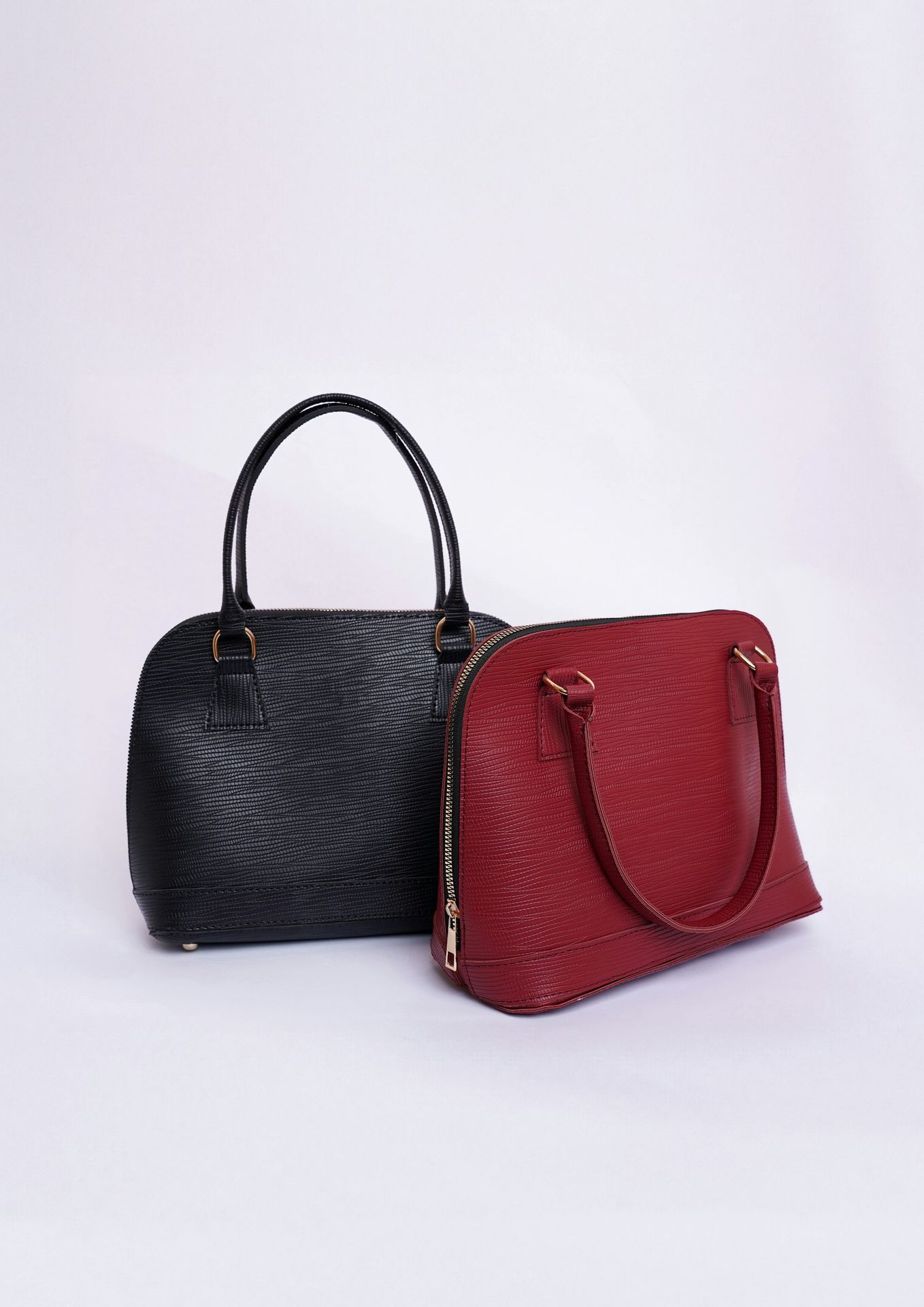 a black and a red handbag on a white background
